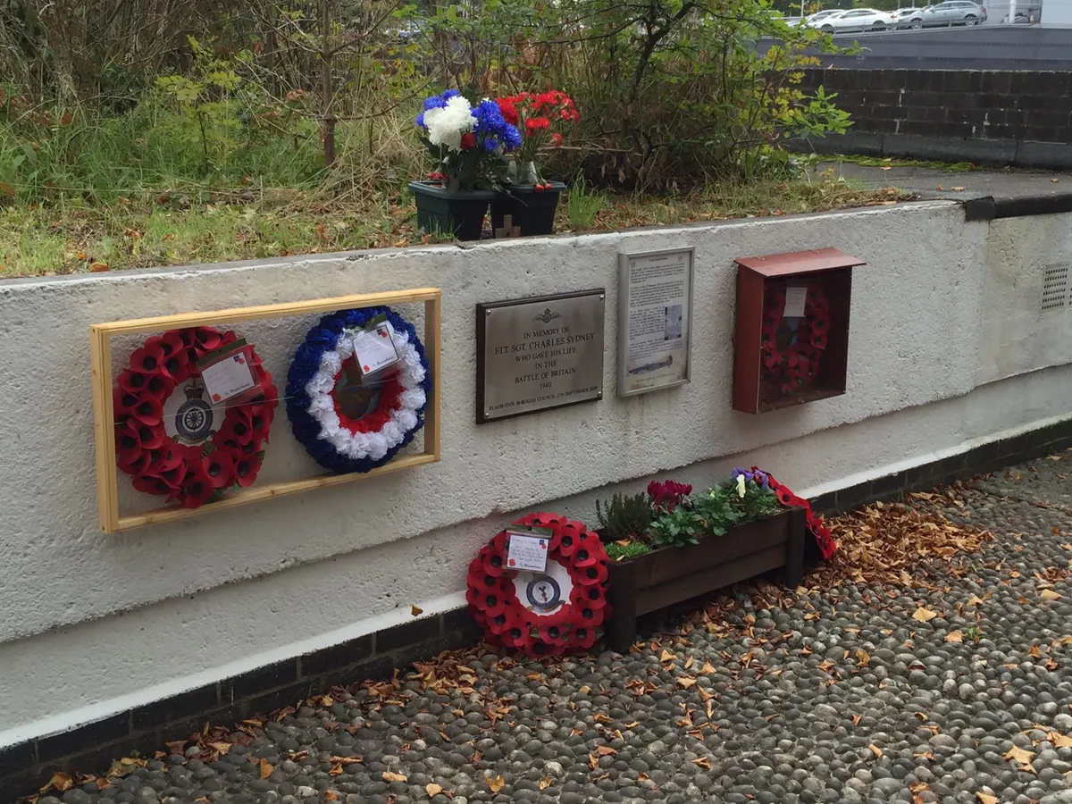 The original 2000 memorial plaque to Flight Sergeant Charles Sydney beside Walton Court, Station Avenue