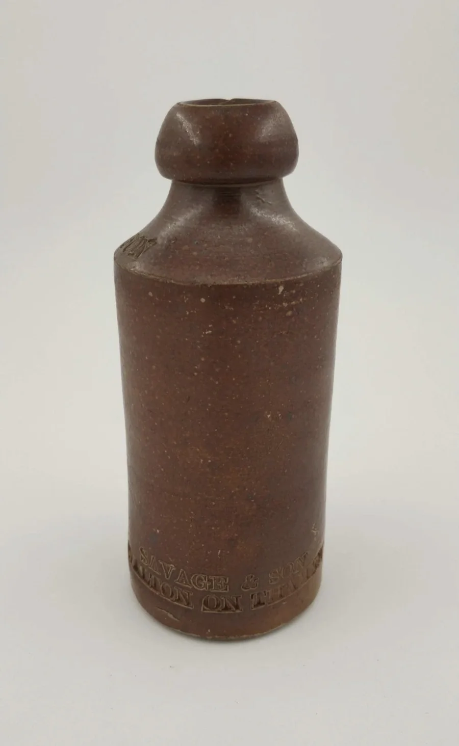 A salt-glazed stoneware Savage & Son bottle, of the type used for ginger beer
