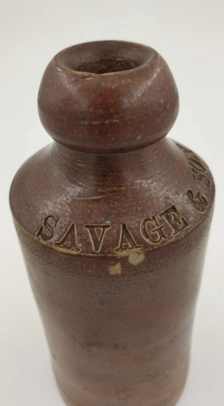 The neck and shoulder of the stoneware Savage & Son bottle