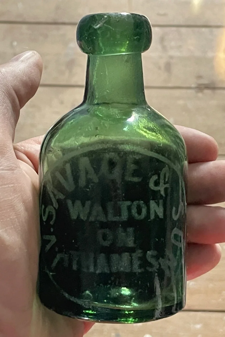 A dark green Savage & Son bottle, embossed 'J. V. Savage & Son, Walton on Thames'