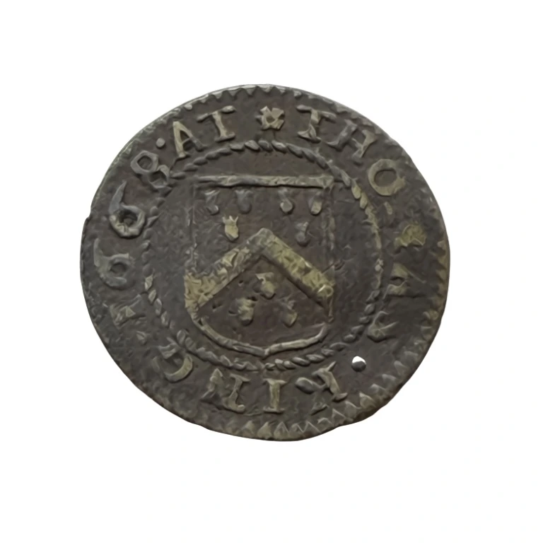 Thomas King's 1668 Walton-on-Thames halfpenny, obverse, showing THOMAS KING 1668 AT around the Grocers' Arms